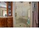 Elegant bathroom with a decorative glass shower door, patterned tile, and built-in vanity storage at 8649 S Willow Dr, Tempe, AZ 85284