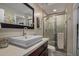 Contemporary bathroom with a stylish vessel sink, sleek mirror, and a walk-in shower with modern fixtures at 8649 S Willow Dr, Tempe, AZ 85284