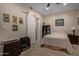 Cozy bedroom with soft lighting, ceiling fan, Star Wars art, and tiled flooring at 8649 S Willow Dr, Tempe, AZ 85284