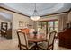 Elegant dining room with a round table, chairs, decorative chandelier, and wood trim at 8649 S Willow Dr, Tempe, AZ 85284