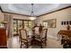 Elegant dining room with a round table, chairs, decorative chandelier, and wood trim at 8649 S Willow Dr, Tempe, AZ 85284