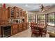 Dining room with wood table, adjacent storage, tile floors, and natural light from outdoor views at 8649 S Willow Dr, Tempe, AZ 85284