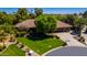 An aerial view of a well-maintained home with lush lawn, mature trees, and desert landscaping at 8649 S Willow Dr, Tempe, AZ 85284