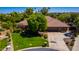 Aerial view of a home showcasing lush front lawn, mature landscaping, and a circular driveway at 8649 S Willow Dr, Tempe, AZ 85284
