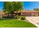 Inviting single-story brick home featuring a well-manicured lawn and a spacious driveway at 8649 S Willow Dr, Tempe, AZ 85284