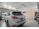 Spacious garage features built-in storage cabinets and parking for a white Lexus at 8649 S Willow Dr, Tempe, AZ 85284