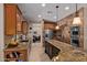 Modern kitchen featuring granite countertops, stainless steel appliances, and an eat-in bar at 8649 S Willow Dr, Tempe, AZ 85284