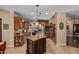 A gourmet kitchen features a granite island, custom cabinets, and stainless steel appliances at 8649 S Willow Dr, Tempe, AZ 85284