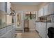 Laundry room with washer, dryer, granite countertops, utility sink, and exterior access at 8649 S Willow Dr, Tempe, AZ 85284