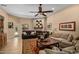 Spacious living room with a stone fireplace, wood mantel, and comfortable seating arrangement at 8649 S Willow Dr, Tempe, AZ 85284