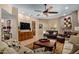 Large, open living area with a stone fireplace and a view to the exterior through a sliding glass door at 8649 S Willow Dr, Tempe, AZ 85284