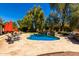 Relaxing pool area with waterfalls, stone patio, and landscaping at 8649 S Willow Dr, Tempe, AZ 85284