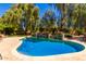 Beautiful pool area with tiled deck, raised planters, and lush landscaping at 8649 S Willow Dr, Tempe, AZ 85284