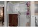 Bathroom shower with glass door, white subway tile, shower caddy and grab bar at 8649 S Willow Dr, Tempe, AZ 85284