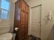 Well-lit bathroom with wooden cabinet and convenient toilet placement at 8700 E University Dr # 1947, Mesa, AZ 85207