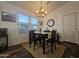 Well-lit dining area featuring a table with four chairs, wood-look floors, and a modern light fixture at 8700 E University Dr # 1947, Mesa, AZ 85207