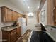 Close-up of a bright kitchen featuring wood cabinets, granite countertops, modern appliances, and wood-look floors at 8700 E University Dr # 1947, Mesa, AZ 85207
