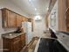 Well-lit kitchen with wooden cabinets, granite countertops, and white appliances at 8700 E University Dr # 1947, Mesa, AZ 85207