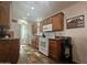Functional kitchen with wood cabinets, white appliances, and granite countertops offering ample workspace at 8700 E University Dr # 1947, Mesa, AZ 85207