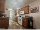 Functional kitchen with wood cabinets, white appliances, and granite countertops offering ample workspace at 8700 E University Dr # 1947, Mesa, AZ 85207