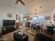 Bright and airy living room with wood-look floors, open layout to kitchen, dining area, and comfortable seating at 8700 E University Dr # 1947, Mesa, AZ 85207