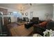 Inviting living room with wood-look floors, neutral walls, comfortable seating, and a dining table at 8700 E University Dr # 1947, Mesa, AZ 85207