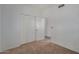 Bright bedroom featuring neutral carpet, white walls, and closet space at 8888 N 47Th Ave # 107, Glendale, AZ 85302