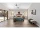 Bedroom with a ceiling fan and sliding glass doors that seamlessly connect indoor and outdoor spaces at 8905 E Hercules Ct, Sun Lakes, AZ 85248