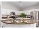 Kitchen island featuring granite countertop and stainless steel appliances, plus white cabinetry at 8905 E Hercules Ct, Sun Lakes, AZ 85248