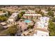 Aerial view of residential community featuring a pool, landscaping, parking, and multiple residential buildings at 9450 E Becker Ln # 2019, Scottsdale, AZ 85260