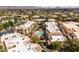 Aerial view of the community showing mature landscaping, a pool, residential buildings, and parking at 9450 E Becker Ln # 2019, Scottsdale, AZ 85260
