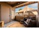 Charming balcony with a unique hanging chair, decorative rug, and views of the neighborhood at 9450 E Becker Ln # 2019, Scottsdale, AZ 85260