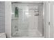 Bathroom featuring a modern shower with glass door and white marble-look tiling at 9450 E Becker Ln # 2019, Scottsdale, AZ 85260
