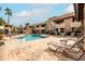 Community pool with lounge chairs and well-maintained landscaping at 9450 E Becker Ln # 2019, Scottsdale, AZ 85260