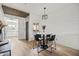 Bright dining area features a marble table, black chairs, a modern light fixture, and a shiplap accent wall at 9450 E Becker Ln # 2019, Scottsdale, AZ 85260