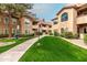 Well-maintained condo buildings with lush green lawns and pathways in a vibrant community at 9450 E Becker Ln # 2019, Scottsdale, AZ 85260
