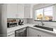 Bright kitchen featuring white cabinetry, stainless steel appliances, and a window view at 9450 E Becker Ln # 2019, Scottsdale, AZ 85260