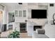 Stylish living room featuring a marble fireplace, a bar area, and a view into the bedroom at 9450 E Becker Ln # 2019, Scottsdale, AZ 85260
