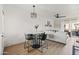 Open-concept living room with dining area, shiplap wall, modern light fixture, and sliding glass door to balcony at 9450 E Becker Ln # 2019, Scottsdale, AZ 85260