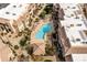 Aerial view of a residential community pool with lounge chairs and desert landscaping around property at 9450 E Becker Ln # 2019, Scottsdale, AZ 85260