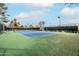 Community tennis courts with green and blue surface and surrounding shade trees at 9450 E Becker Ln # 2019, Scottsdale, AZ 85260