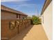 A simple desert backyard with a gravel ground cover and potted plant wall at 10343 E Durant Dr, Mesa, AZ 85212