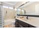 Clean bathroom with a tub-shower combo, modern vanity, and large mirror providing ample light and space at 10500 E Mission Ln, Scottsdale, AZ 85258