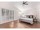 Bright bedroom featuring plantation shutters, hardwood floors, and lots of natural light at 10500 E Mission Ln, Scottsdale, AZ 85258