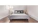 Cozy bedroom showcasing wood floors, soft lighting, and a comfortable queen size bed at 10500 E Mission Ln, Scottsdale, AZ 85258