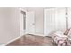 Bright bedroom with a neutral palette, hardwood floors, and a glimpse into the adjacent room at 10500 E Mission Ln, Scottsdale, AZ 85258