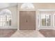 Spacious front entry with tiled floors, double doors and decorative shuttered windows at 10500 E Mission Ln, Scottsdale, AZ 85258