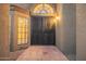 Arched doorway and double front door with decorative window, and terracotta tiled porch at 10500 E Mission Ln, Scottsdale, AZ 85258