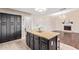 Spacious kitchen with a granite island, dark cabinets, and eat-in seating at 10500 E Mission Ln, Scottsdale, AZ 85258