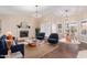 Bright living room showcases a modern fireplace, stylish seating, and a dining area with beautiful natural light at 10500 E Mission Ln, Scottsdale, AZ 85258